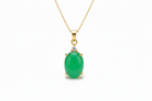 Gold necklace with a green pendant on a white background