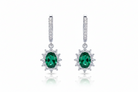 Pair of emerald and diamond earrings on a white background