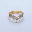 Gold and silver ring with diamond accents on a light gray background