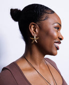 Woman wearing a star-shaped earring on a white background
