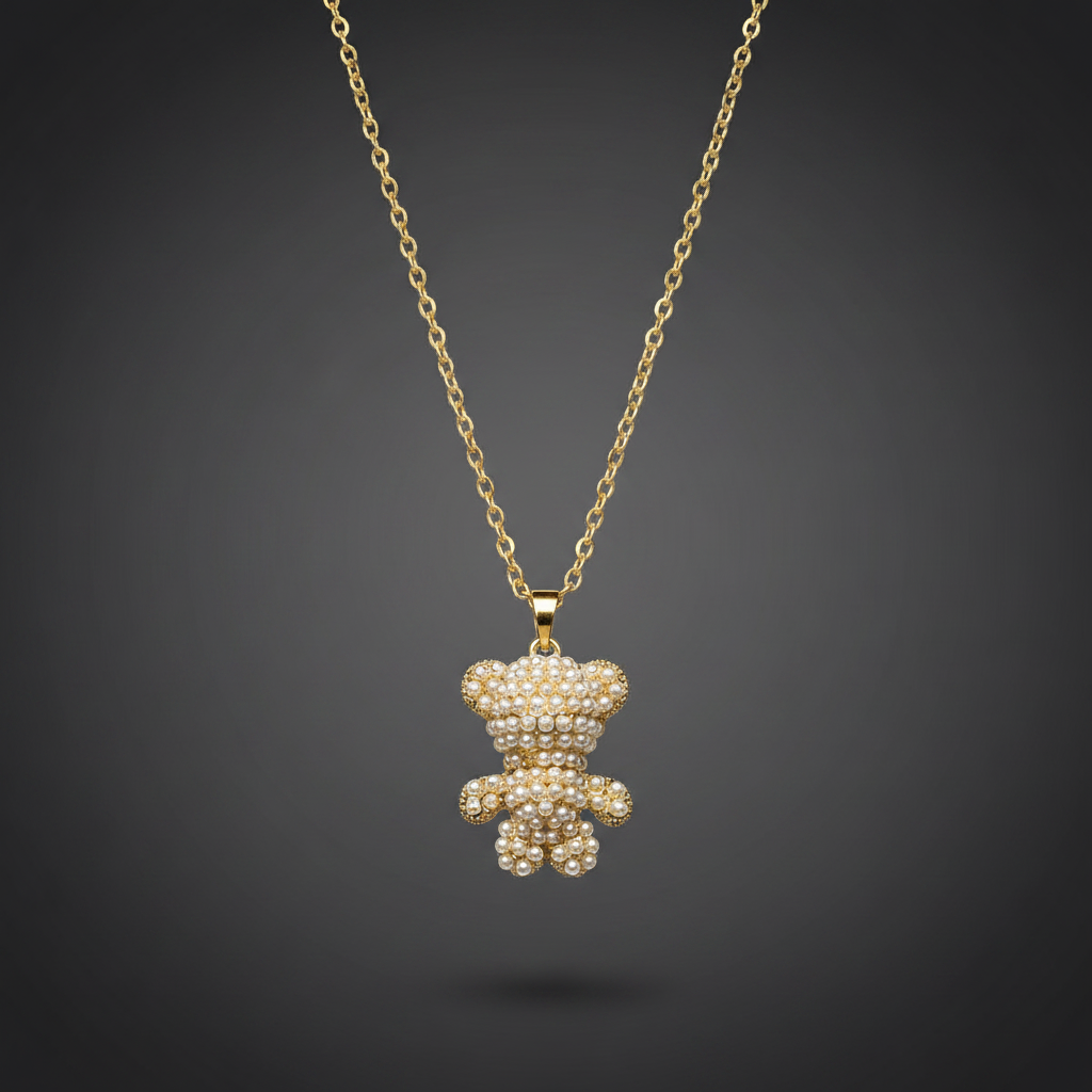 Gold teddy bear pendant necklace on a dark background