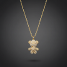 Gold teddy bear pendant necklace on a dark background