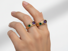 Hand wearing a ring with gemstones on a smartphone screen with editing options.
