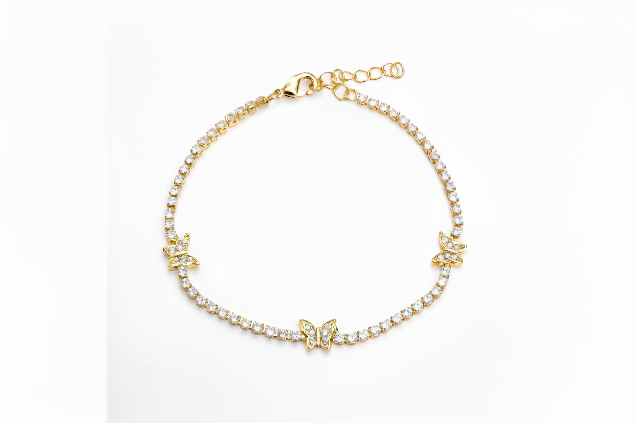 Gold bracelet with butterfly charms on a white background