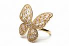 Gold butterfly-shaped ring with diamond accents on a white background