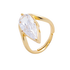 Gold ring with a clear gemstone on a light gray background