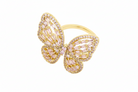 Gold butterfly ring with gemstones on a white background