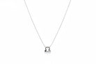 Silver Libra zodiac necklace on a white surface