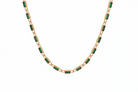 Necklace with green gemstones on a white background 