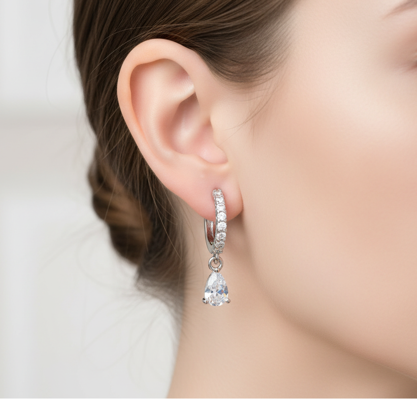 Close-up of a woman wearing a diamond earring with a blurred background