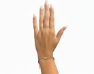 Hand wearing a silver ring and bracelet on a white background