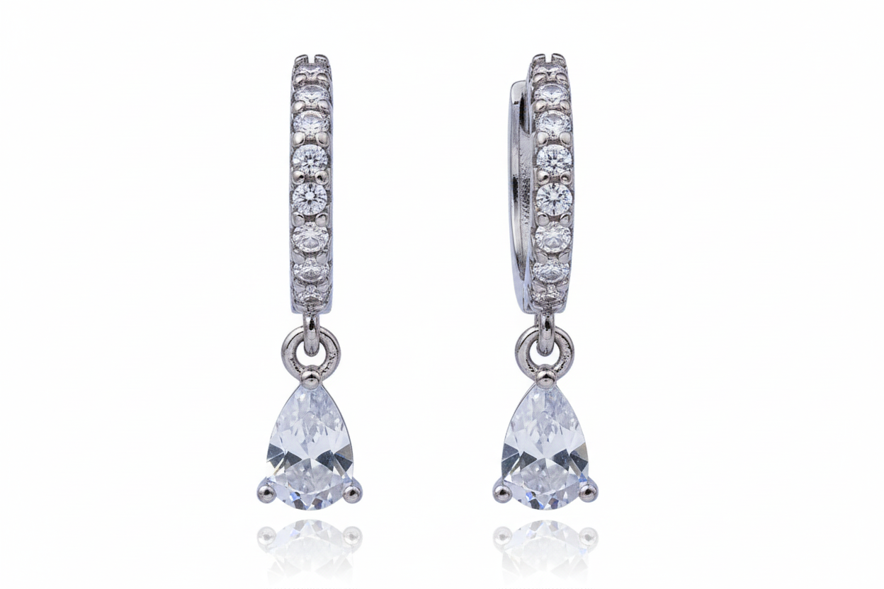 Pair of diamond earrings with teardrop-shaped gemstones on a white background