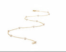 Gold necklace with pearls on a white background