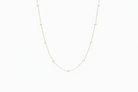 Delicate necklace with small beads on a white background