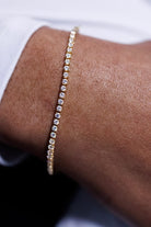 Diamond bracelet on a wrist with a blurred background