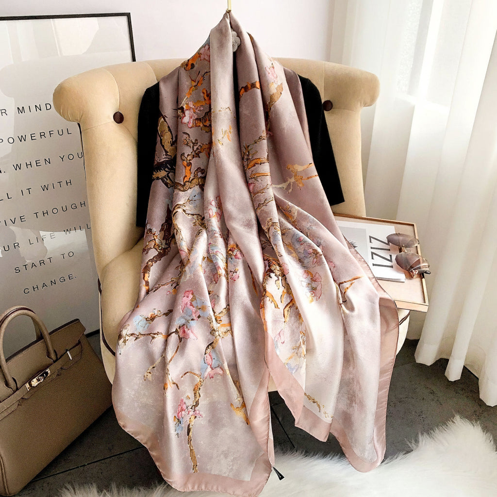 Decorative scarf with floral pattern draped over a chair in a room.
