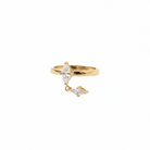 A gold ring featuring a marquise-cut clear gemstone and a smaller dangling marquise-cut gemstone, photographed on a clean white background.