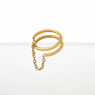 A gold-toned double-band ring with a short chain extension, shown on a clean white background.