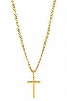Gold cross necklace on a white background