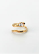 A gold-plated stainless steel snake ring with a marquise-cut clear gemstone on a plain white background, with product specifications printed in black text in the bottom-left corner.