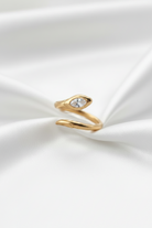 Gold snake-shaped ring on a white background