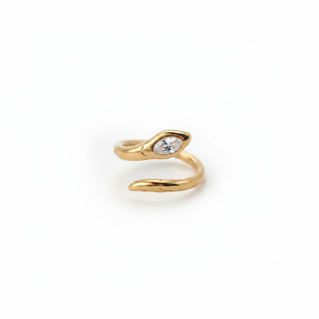 A gold snake-shaped ring with a marquise-cut clear gemstone, photographed on a clean white background.