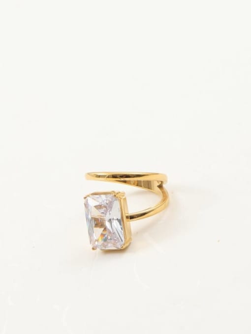 A gold ring with a large rectangular clear gemstone, photographed on a plain white background.