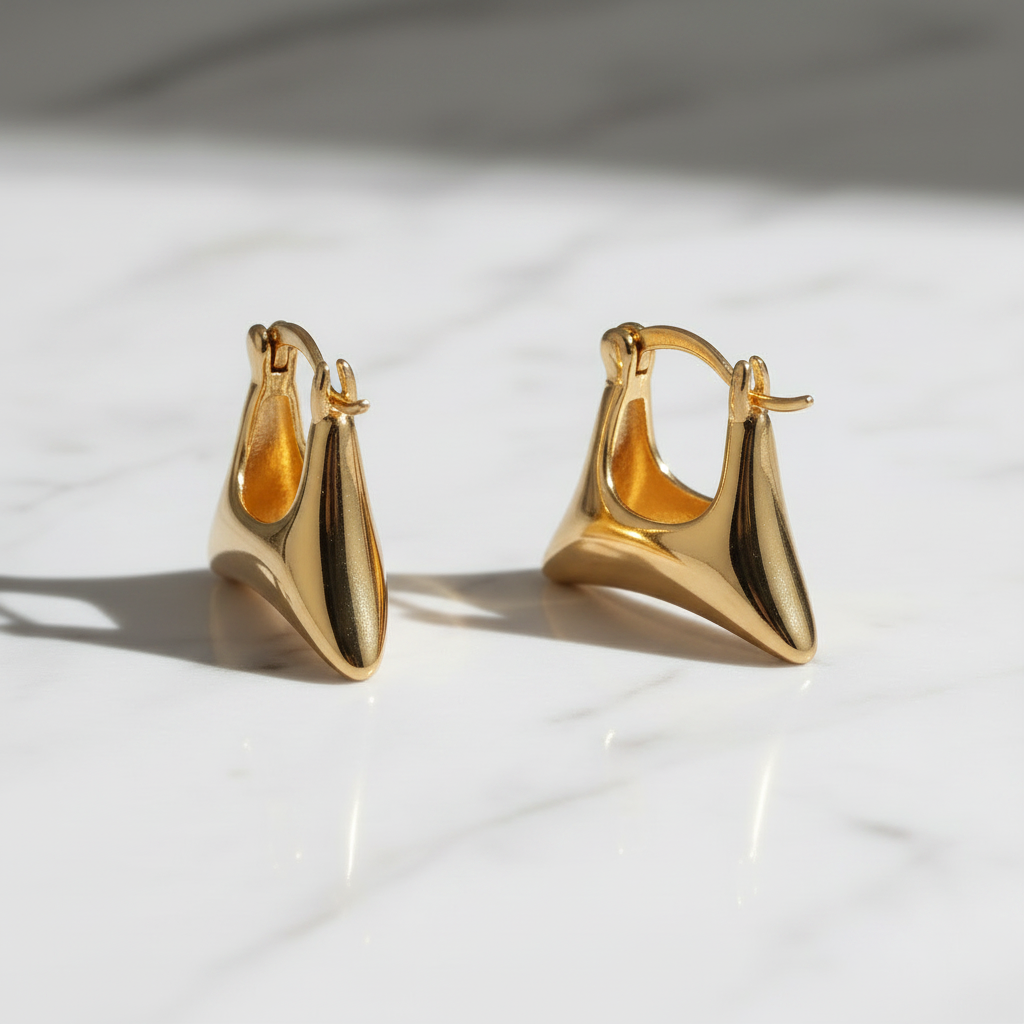 Pair of gold hoop earrings on a light background