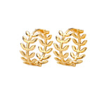 Pair of gold hoop earrings with leaf-like designs on a white background