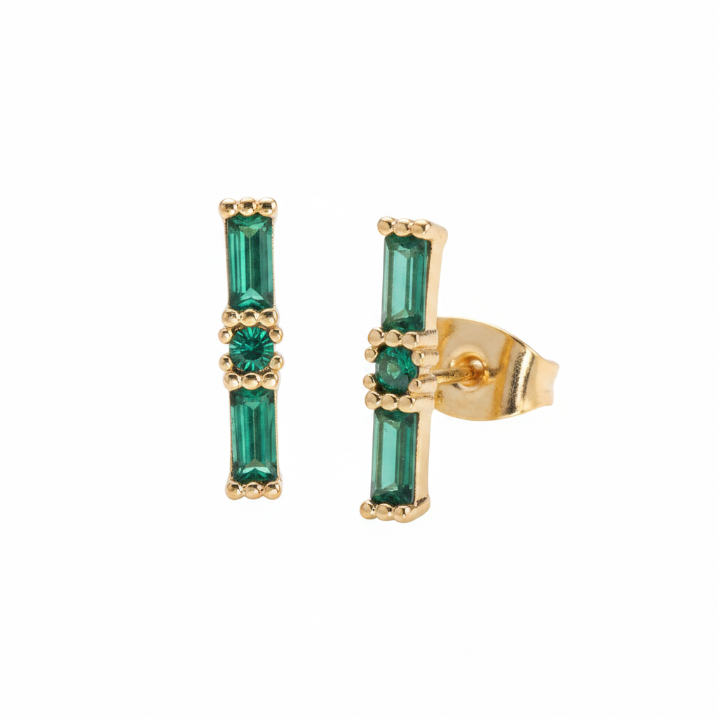 Gold earrings with green gemstones on a white background