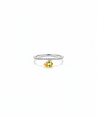 Ring with a pear-shaped yellow gemstone on a white background