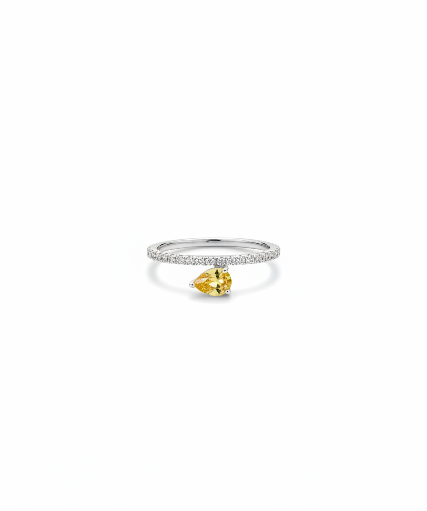 Ring with a pear-shaped yellow gemstone on a white background