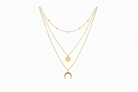 Gold necklace with multiple layers on a white background