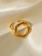 Gold ring on a beige fabric background
