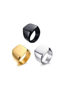 Three metallic rings in black, gold, and silver on a white background