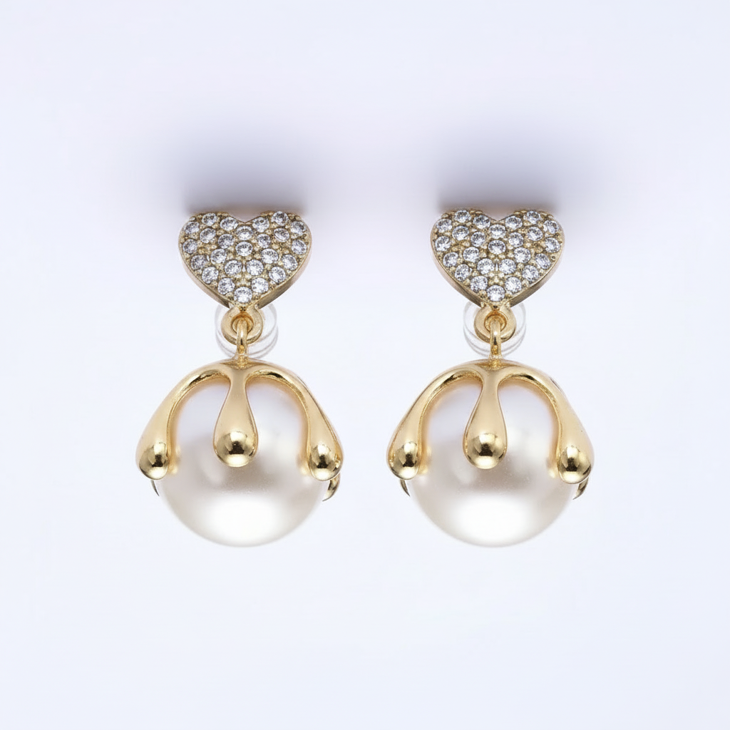 Pair of gold and pearl earrings on a white background