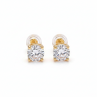 Gold earrings with clear gemstones on a light gray background