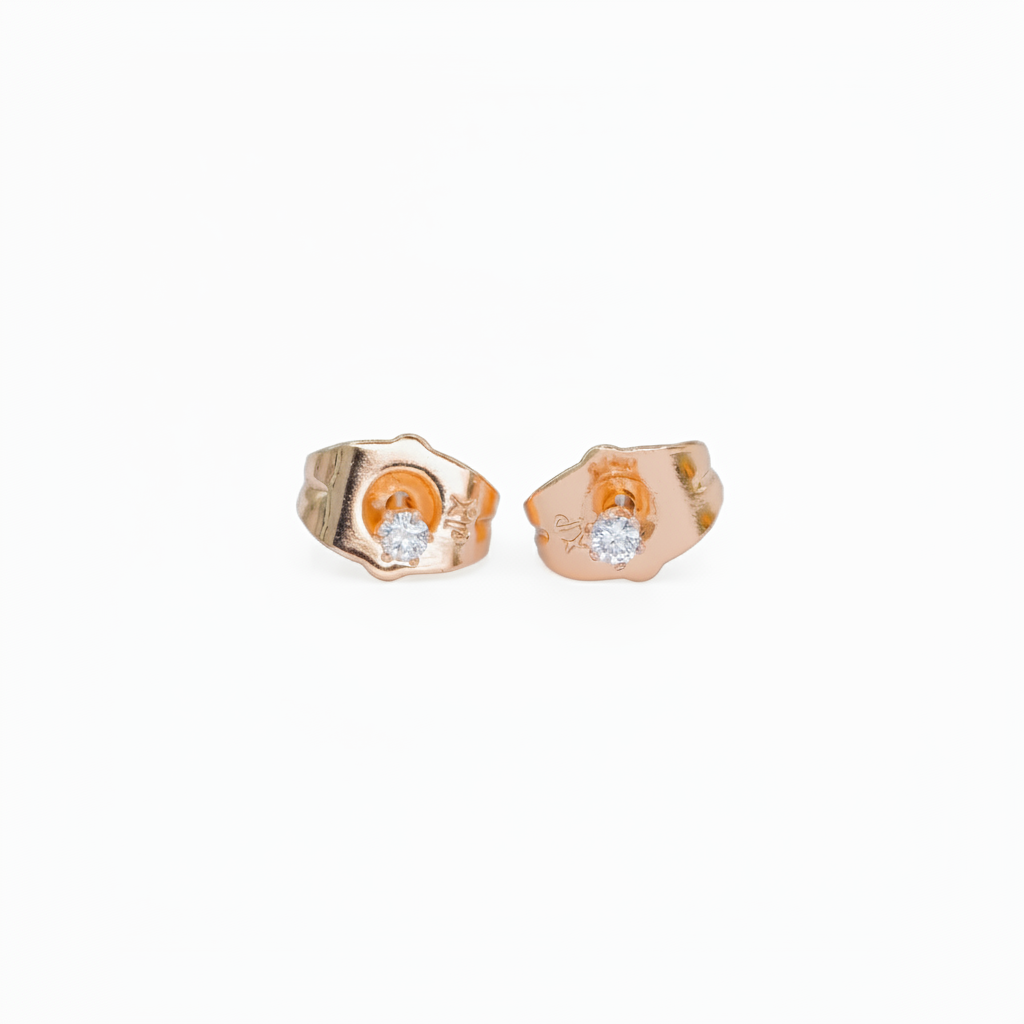 Pair of gold earrings with embedded diamonds on a white background