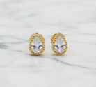 Gold teardrop earrings with clear gemstones on a white background