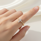 Gold bracelet with a cross charm on a white background