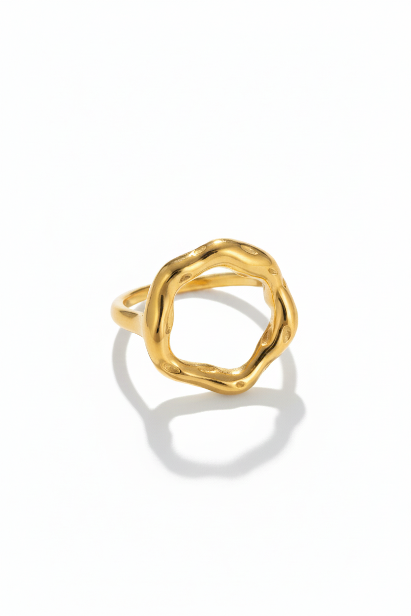 Gold ring with a textured design on a white background
