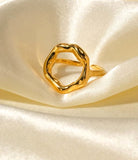 Gold ring on a satin surface