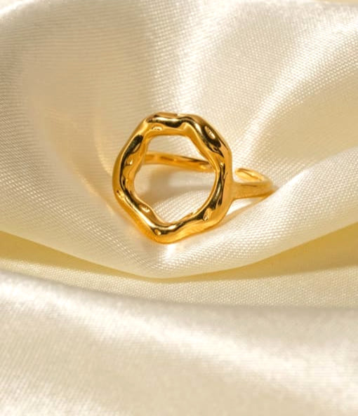 Gold ring on a satin surface