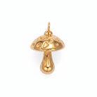 Gold mushroom-shaped pendant on a light purple background