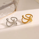 Gold and silver open rings on a light background
