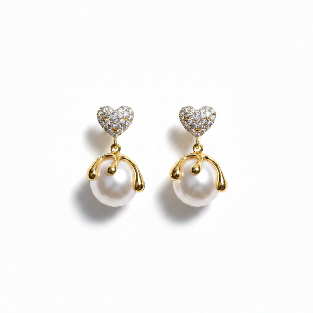Pair of heart-shaped earrings with pearls on a white background