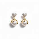 Pair of heart-shaped earrings with pearls on a white background