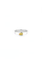 Ring with a yellow gemstone on a white background