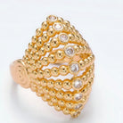Gold ring with diamond accents on a white background