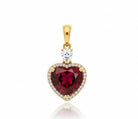 Gold pendant with a heart-shaped red gemstone and clear stones on a white background